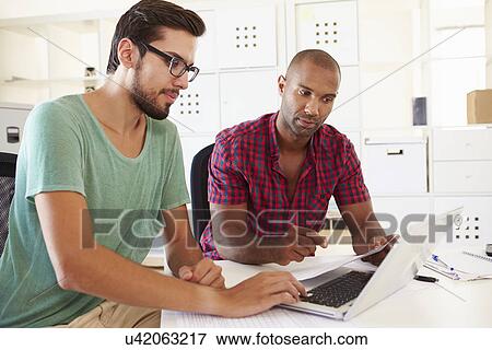 Businessmen Using Laptop In Office Of Start Up Business View Large Photo Image Stock Photo - Businessmen Using Laptop In Office Of Start Up Business. Fotosearch