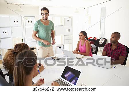 Stock Image - Businesspeople Meeting In Office Of Start Up Business. Fotosearch