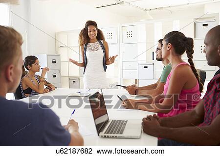 Stock Image - Businesspeople Meeting In Office Of Start Up Business. Fotosearch