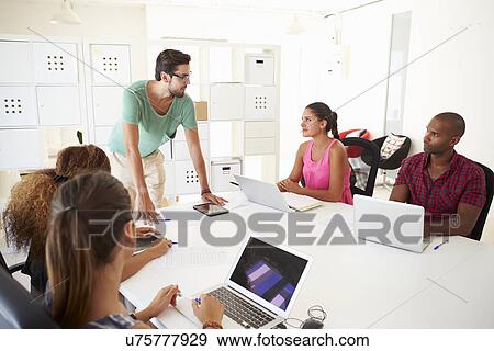 Businesspeople Meeting In Office Of Start Up Business View Large Photo Image Stock Photo - Businesspeople Meeting In Office Of Start Up Business. Fotosearch