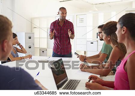Businesspeople Meeting In Office Of Start Up Business View Large Photo Image Stock Photography - Businesspeople Meeting In Office Of Start Up Business. Fotosearch