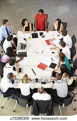 Businesswoman Addressing Meeting Around Boardroom Table View Large Photo Image Stock Image - Businesswoman Addressing Meeting Around Boardroom Table. Fotosearch