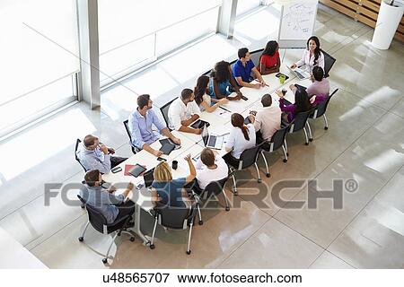 Businesswoman Addressing Meeting Around Boardroom Table View Large Photo Image Stock Photo - Businesswoman Addressing Meeting Around Boardroom Table. Fotosearch