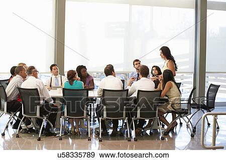 Businesswoman Addressing Meeting Around Boardroom Table View Large Photo Image Stock Photo - Businesswoman Addressing Meeting Around Boardroom Table. Fotosearch