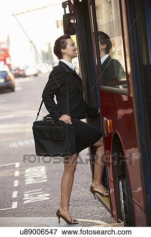 Stock Photo - Businesswoman boarding bus. Fotosearch