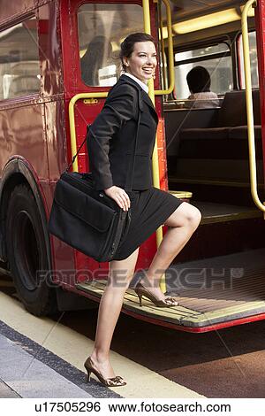 Businesswoman boarding Routemaster bus View Large Photo Image Stock Photograph - Businesswoman boarding Routemaster bus. Fotosearch