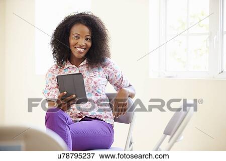 Stock Photo - Businesswoman In Office Using Digital Tablet. Fotosearch