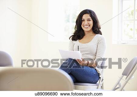Stock Image - Businesswoman Making Notes On Document. Fotosearch
