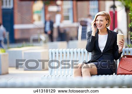 Businesswoman On Park Bench With Coffee Using Mobile Phone View Large Photo Image Stock Photo - Businesswoman On Park Bench With Coffee Using Mobile Phone. Fotosearch