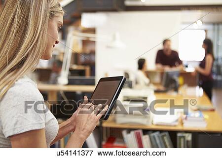 Businesswoman Using Digital Tablet In Modern Office View Large Photo Image Stock Photo - Businesswoman Using Digital Tablet In Modern Office. Fotosearch