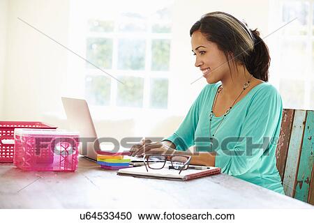Stock Image - Businesswoman Working In Office At Home. Fotosearch