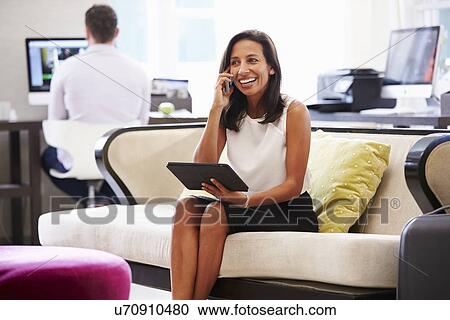 Businesswoman Working On Digital Tablet In Hotel Lobby View Large Photo Image Stock Image - Businesswoman Working On Digital Tablet In Hotel Lobby. Fotosearch