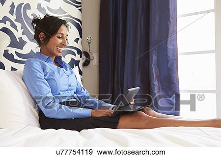 Businesswoman Working On Digital Tablet In Hotel Room View Large Photo Image Stock Photo - Businesswoman Working On Digital Tablet In Hotel Room. Fotosearch