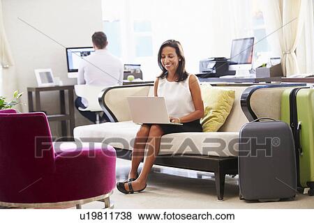 Businesswoman Working On Laptop In Hotel Lobby View Large Photo Image Stock Photo - Businesswoman Working On Laptop In Hotel Lobby. Fotosearch