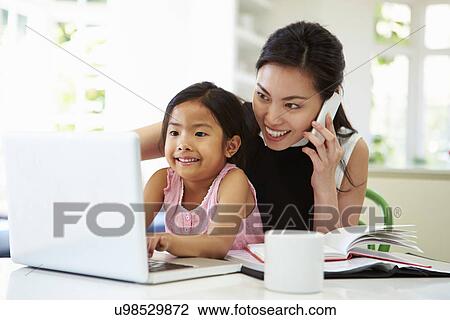 Busy Mother Working From Home With Daughter View Large Photo Image Stock Image - Busy Mother Working From Home With Daughter. Fotosearch