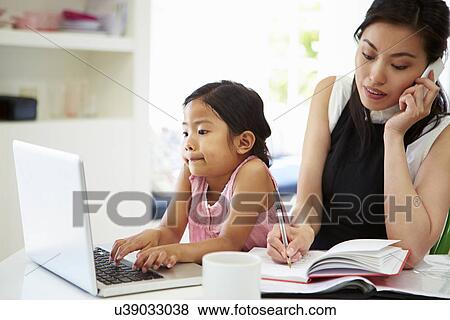 Busy Mother Working From Home With Daughter View Large Photo Image Stock Photo - Busy Mother Working From Home With Daughter. Fotosearch