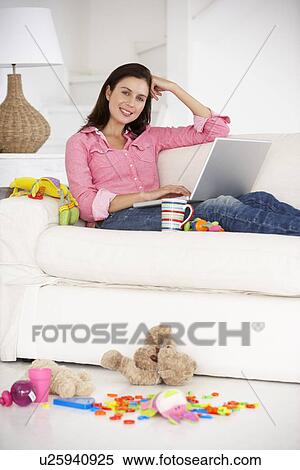 Busy mother working on laptop View Large Photo Image Stock Photography - Busy mother working on laptop. Fotosearch