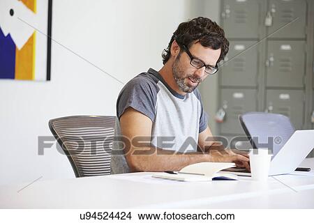 Casually Dressed Man Working In Design Studio View Large Photo Image Picture - Casually Dressed Man Working In Design Studio. Fotosearch