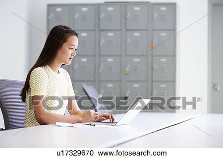 Stock Image - Casually Dressed Woman Working In Design Studio. Fotosearch
