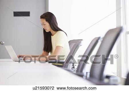 Stock Image - Casually Dressed Woman Working In Design Studio. Fotosearch