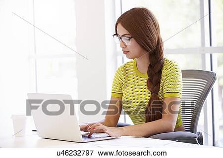 Casually Dressed Woman Working In Design Studio View Large Photo Image Stock Photo - Casually Dressed Woman Working In Design Studio. Fotosearch