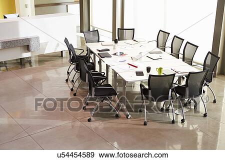 Stock Photo - Chairs Arranged Around Empty Boardroom Table. Fotosearch