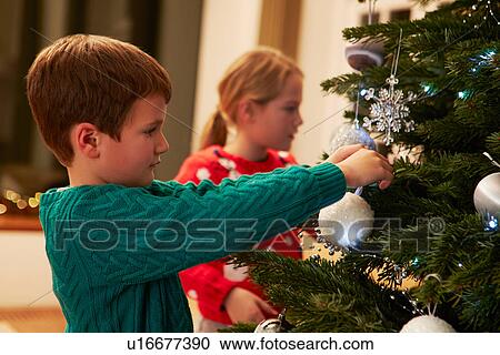 Children Decorating Christmas Tree At Home View Large Photo Image Stock Image - Children Decorating Christmas Tree At Home . Fotosearch
