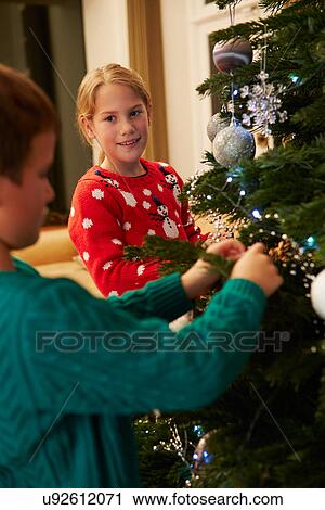 Children Decorating Christmas Tree At Home View Large Photo Image Stock Image - Children Decorating Christmas Tree At Home . Fotosearch