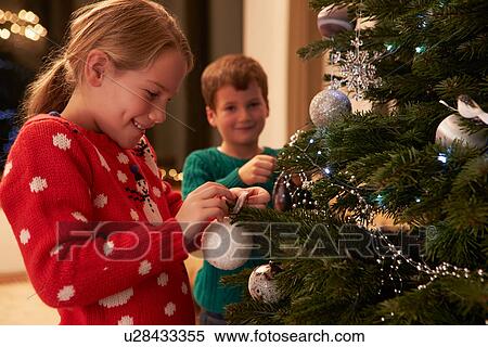 Children Decorating Christmas Tree At Home View Large Photo Image Stock Photography - Children Decorating Christmas Tree At Home . Fotosearch