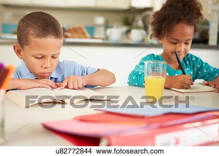 Children Doing Homework Together At Table View Large Photo Image Picture - Children Doing Homework Together At Table. Fotosearch
