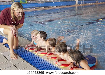 Children having swimming lesson View Large Photo Image Stock Photo - Children having swimming lesson. Fotosearch