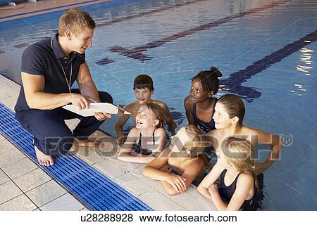 Stock Photo - Children having swimming lesson. Fotosearch