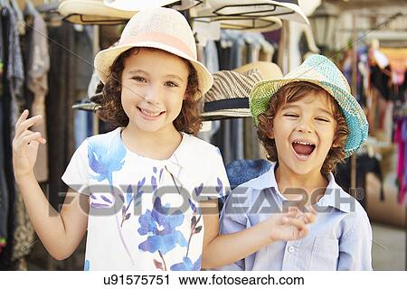 Children On Vacation Trying On Hats At Store View Large Photo Image Stock Image - Children On Vacation Trying On Hats At Store. Fotosearch