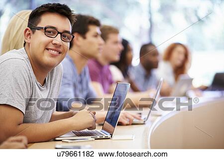 Stock Image - Class Of University Students Using Laptops In Lecture. Fotosearch