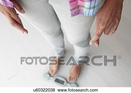 Close up detail girl weighing herself View Large Photo Image Stock Photo - Close up detail girl weighing herself. Fotosearch