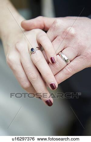 Close Up Of Bride And Groom Wearing Wedding Rings View Large Photo Image Stock Photograph - Close Up Of Bride And Groom Wearing Wedding Rings. Fotosearch