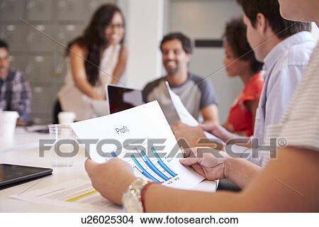 Picture - Close Up Of Businessman Looking At Profit Graph In Meeting. Fotosearch