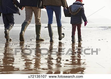 Close Up Of Family Walking Along Winter Beach View Large Photo Image Stock Photo - Close Up Of Family Walking Along Winter Beach. Fotosearch