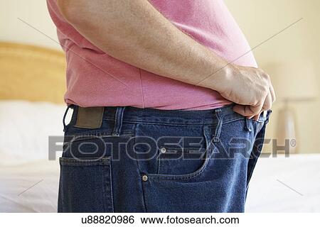 Close Up Of Overweight Man Trying To Fasten Trousers View Large Photo Image Stock Photograph - Close Up Of Overweight Man Trying To Fasten Trousers. Fotosearch