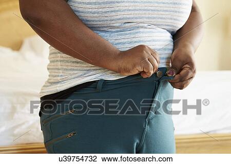 Close Up Of Overweight Woman Trying To Fasten Trousers View Large Photo Image Stock Image - Close Up Of Overweight Woman Trying To Fasten Trousers. Fotosearch
