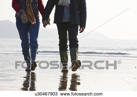 Close Up Of Senior Couple Walking Along Winter Beach View Large Photo Image Stock Image - Close Up Of Senior Couple Walking Along Winter Beach. Fotosearch