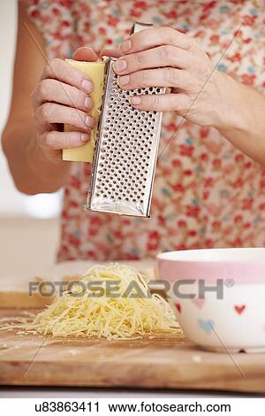 Close Up Of Woman Grating Cheese In Kitchen View Large Photo Image Stock Image - Close Up Of Woman Grating Cheese In Kitchen. Fotosearch