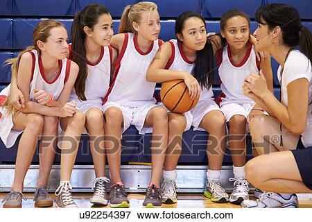 Coach Of Female High School Basketball Team Gives Team Talk View Large Photo Image Stock Photo - Coach Of Female High School Basketball Team Gives Team Talk . Fotosearch