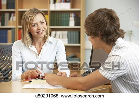 College tutor with student View Large Photo Image Stock Photo - College tutor with student. Fotosearch