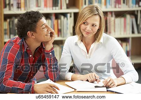 Stock Photo - College tutor with student. Fotosearch