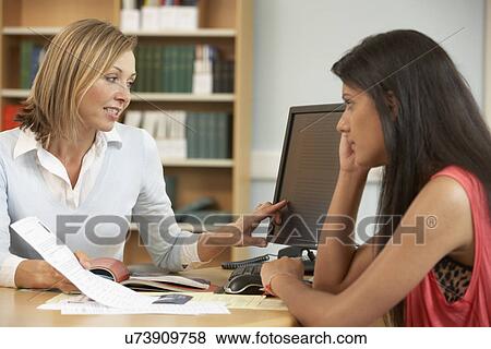 Stock Photo - College tutor with student. Fotosearch
