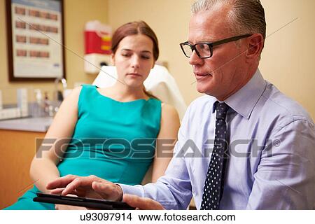 Cosmetic Surgeon Discussing Proceedure With Client In Office View Large Photo Image Picture - Cosmetic Surgeon Discussing Proceedure With Client In Office. Fotosearch