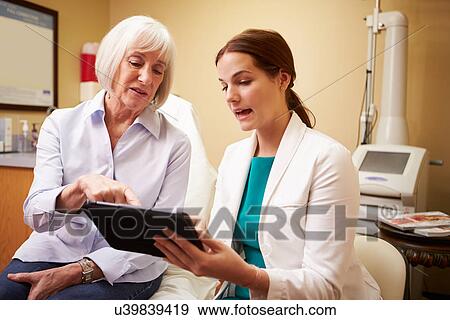 Cosmetic Surgeon Discussing Proceedure With Client In Office View Large Photo Image Stock Photo - Cosmetic Surgeon Discussing Proceedure With Client In Office. Fotosearch