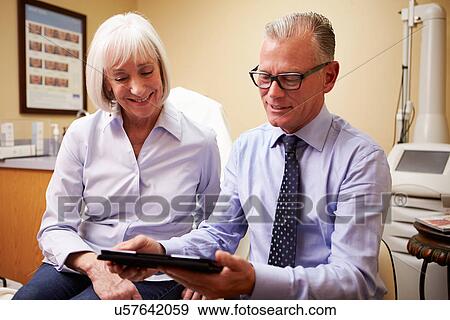 Cosmetic Surgeon Discussing Proceedure With Client In Office View Large Photo Image Stock Photo - Cosmetic Surgeon Discussing Proceedure With Client In Office. Fotosearch