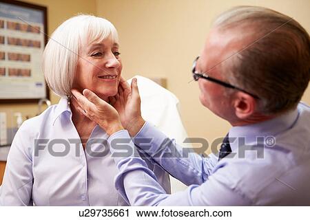 Cosmetic Surgeon Examining Senior Female Client In Office View Large Photo Image Stock Image - Cosmetic Surgeon Examining Senior Female Client In Office. Fotosearch